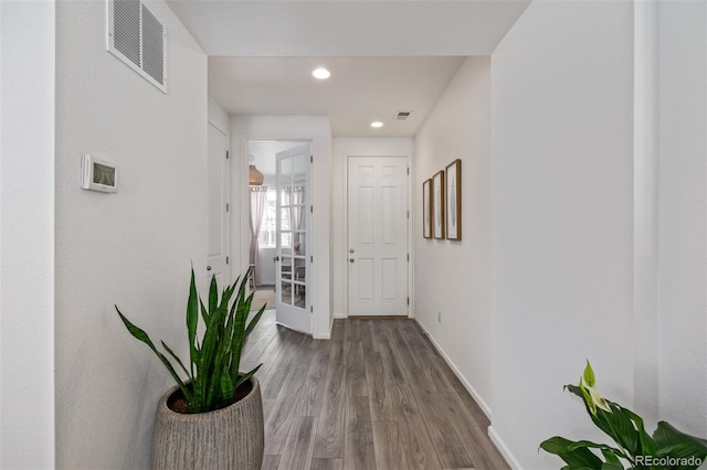 hallway with hardwood / wood-style floors