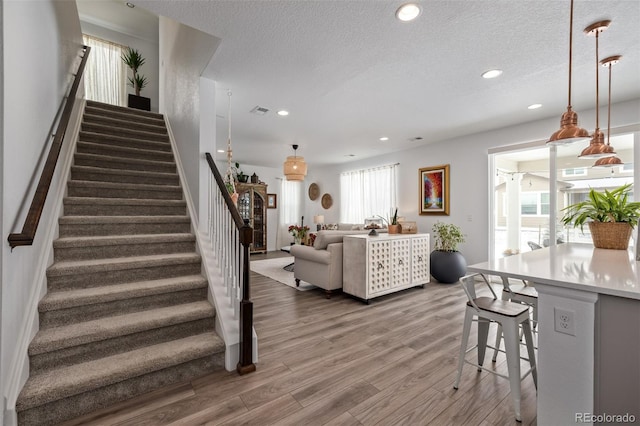 living room featuring hardwood / wood-style flooring and a textured ceiling