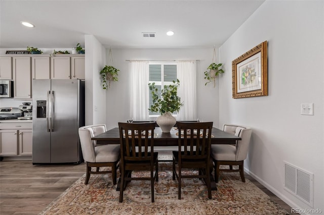 dining room with dark hardwood / wood-style flooring