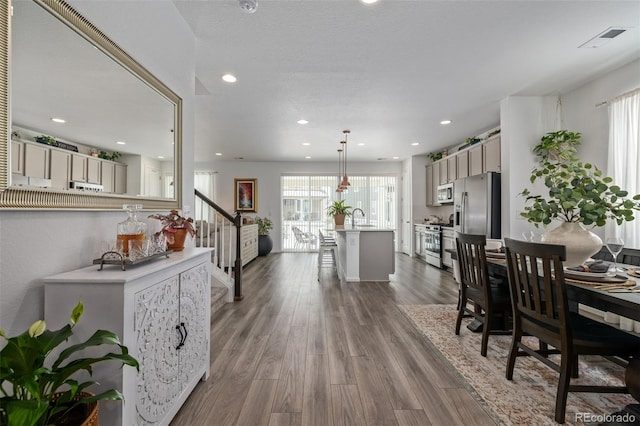 dining area with hardwood / wood-style flooring and sink