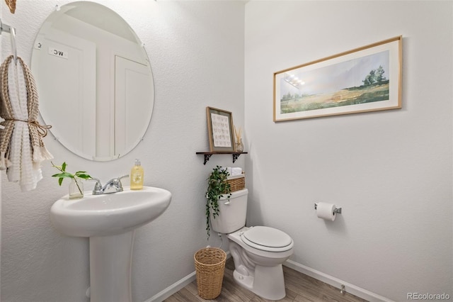 bathroom with sink, hardwood / wood-style floors, and toilet