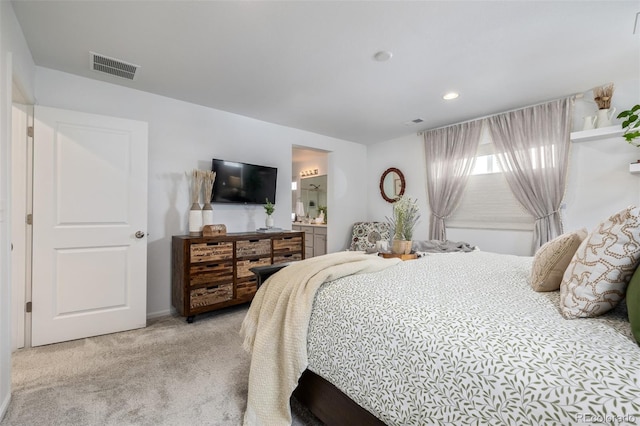 carpeted bedroom featuring ensuite bathroom