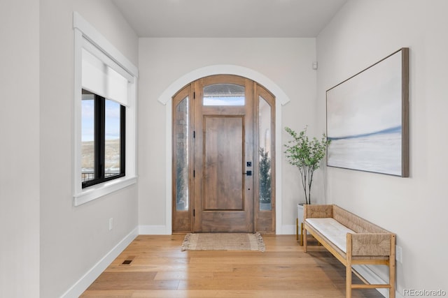 entryway featuring light wood-type flooring, visible vents, and baseboards