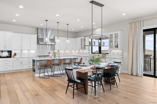 dining space with light wood-style flooring and recessed lighting