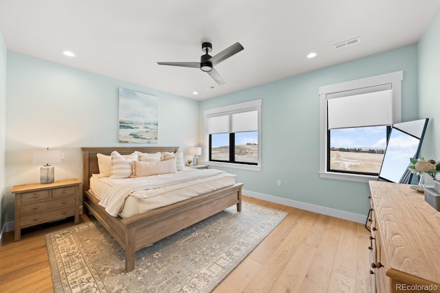 bedroom with recessed lighting, a ceiling fan, visible vents, baseboards, and light wood finished floors