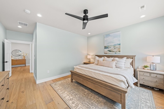 bedroom featuring light wood-type flooring, visible vents, and baseboards