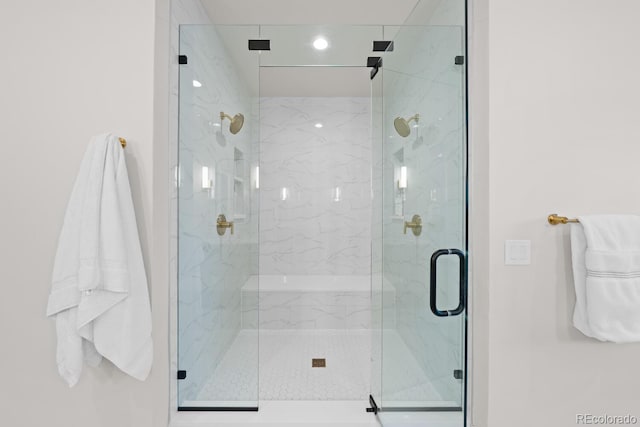 bathroom with a marble finish shower