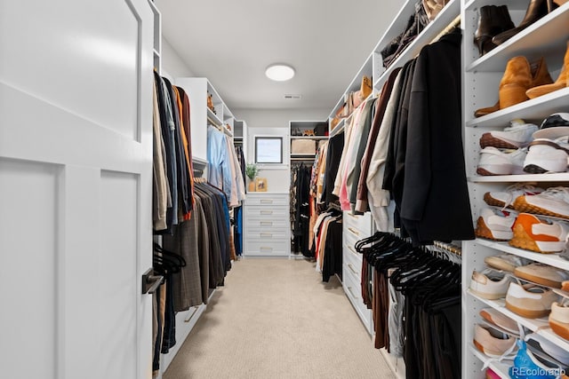 spacious closet featuring light colored carpet and visible vents