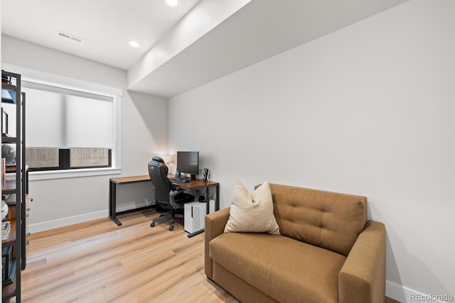 home office featuring light wood-type flooring, baseboards, visible vents, and recessed lighting