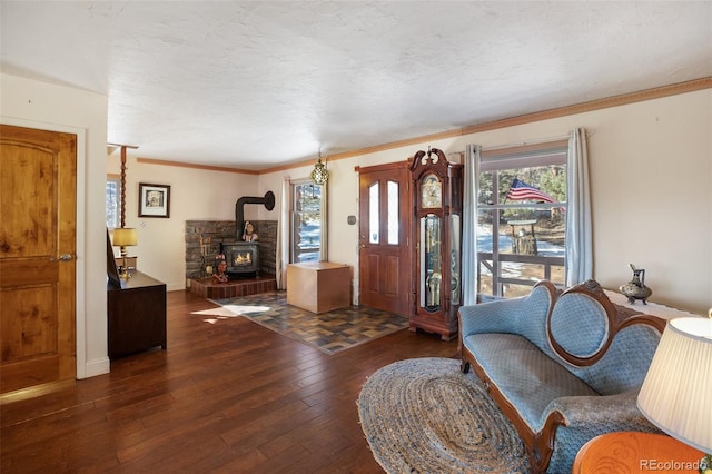 entryway featuring ornamental molding, a textured ceiling, a wood stove, and dark wood-type flooring