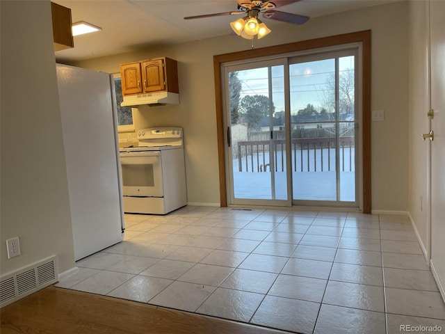 kitchen featuring ceiling fan, light tile patterned floors, electric range, and stainless steel refrigerator