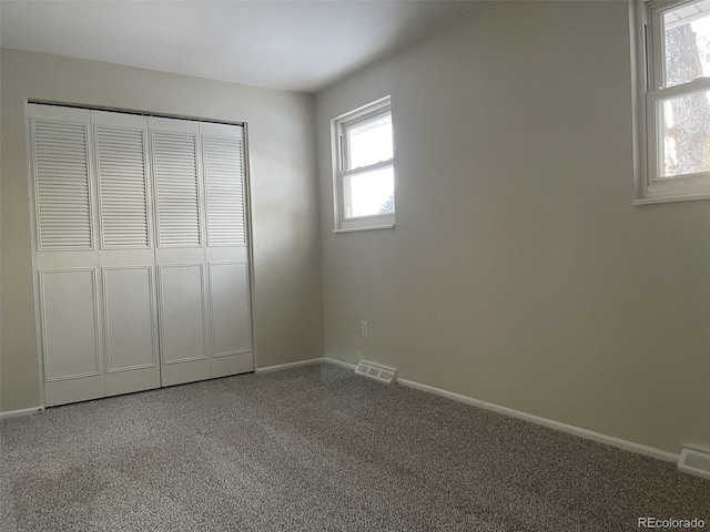 unfurnished bedroom featuring a closet and carpet flooring