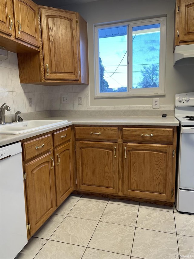 kitchen featuring decorative backsplash, sink, white appliances, and light tile patterned flooring