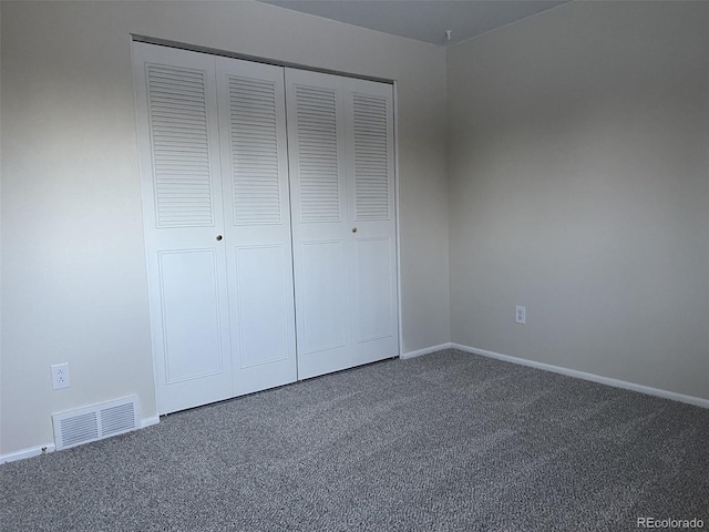 unfurnished bedroom with a closet and carpet floors