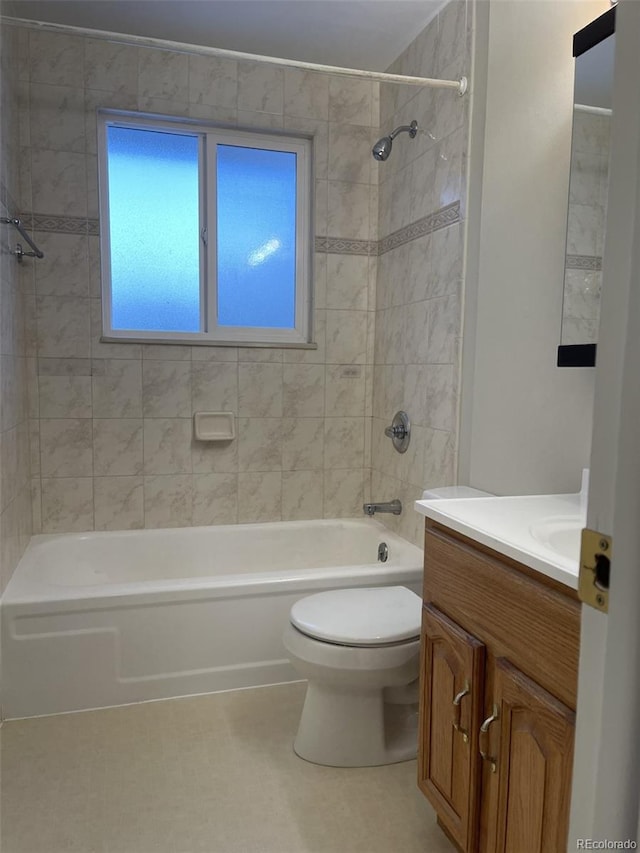 full bathroom with toilet, vanity, and tiled shower / bath