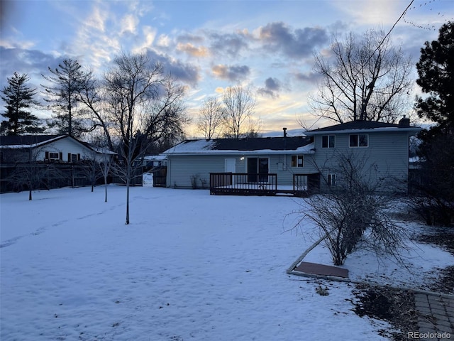 yard layered in snow featuring a wooden deck