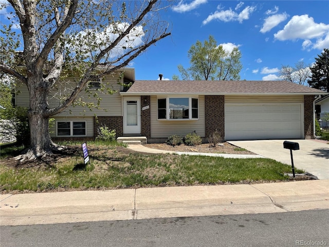 3062 S Florence Ct, Denver, CO 80231 - split level home with brick siding, an attached garage, and driveway