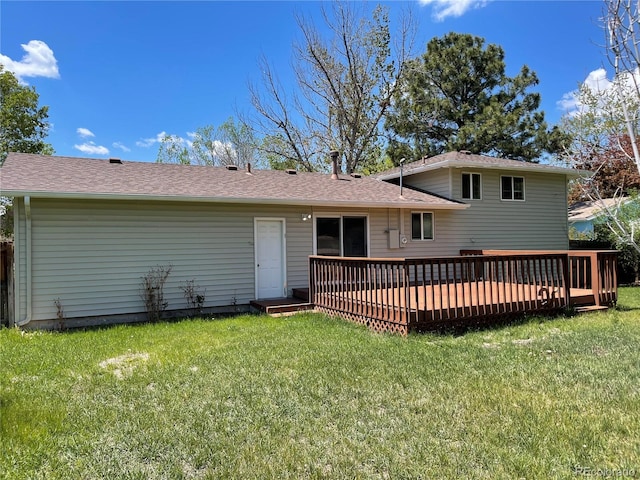 3062 S Florence Ct, Denver, CO 80231 - back of property featuring a yard, a wooden deck, and a shingled roof