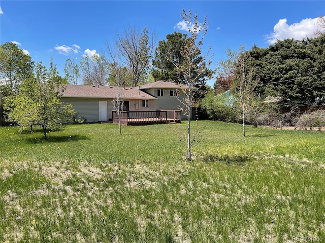 3062 S Florence Ct, Denver, CO 80231 - view of green lawn featuring a wooden deck