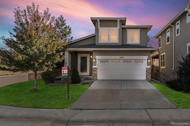 view of front of property featuring a garage and a lawn