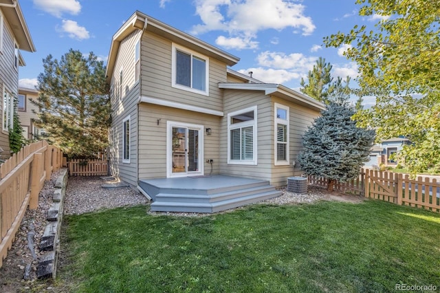 back of house with a deck, central air condition unit, and a lawn