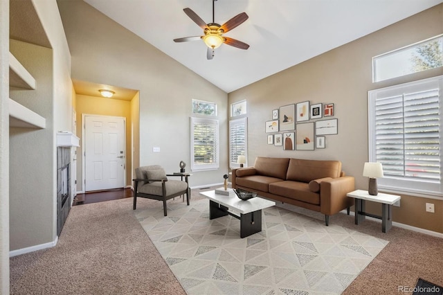 carpeted living room featuring ceiling fan, plenty of natural light, and high vaulted ceiling