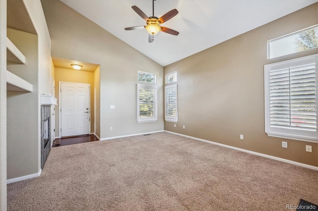 carpeted spare room with high vaulted ceiling and ceiling fan