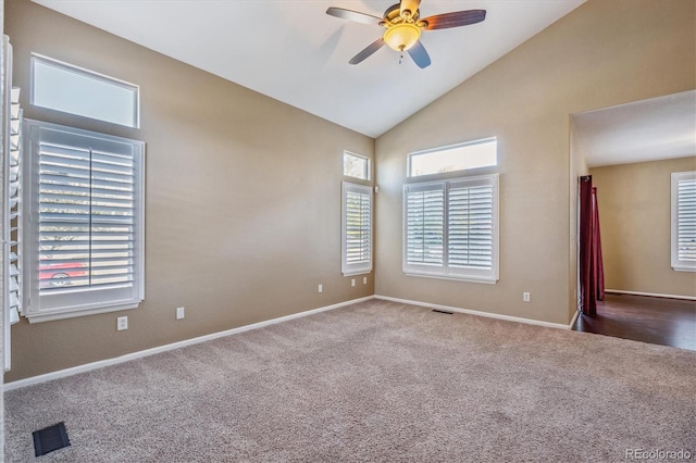 carpeted spare room with high vaulted ceiling, a wealth of natural light, and ceiling fan