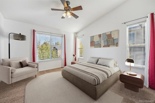 bedroom with ceiling fan, vaulted ceiling, and carpet flooring