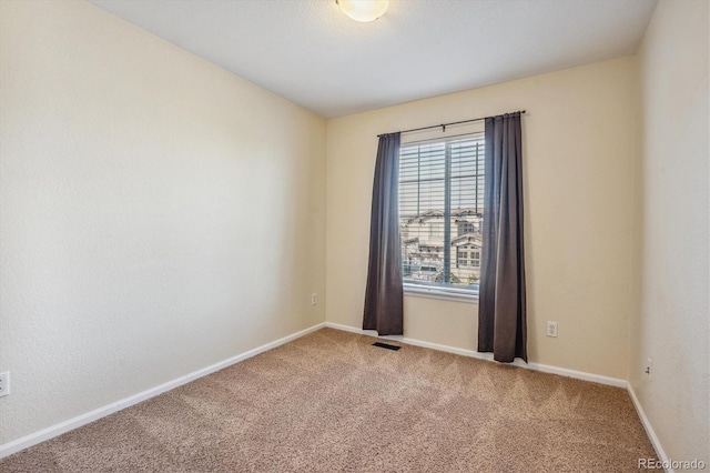 unfurnished room featuring carpet flooring