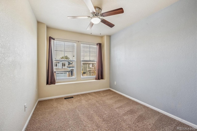 unfurnished room with carpet and ceiling fan