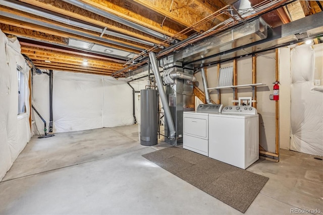 basement featuring gas water heater and washer and clothes dryer