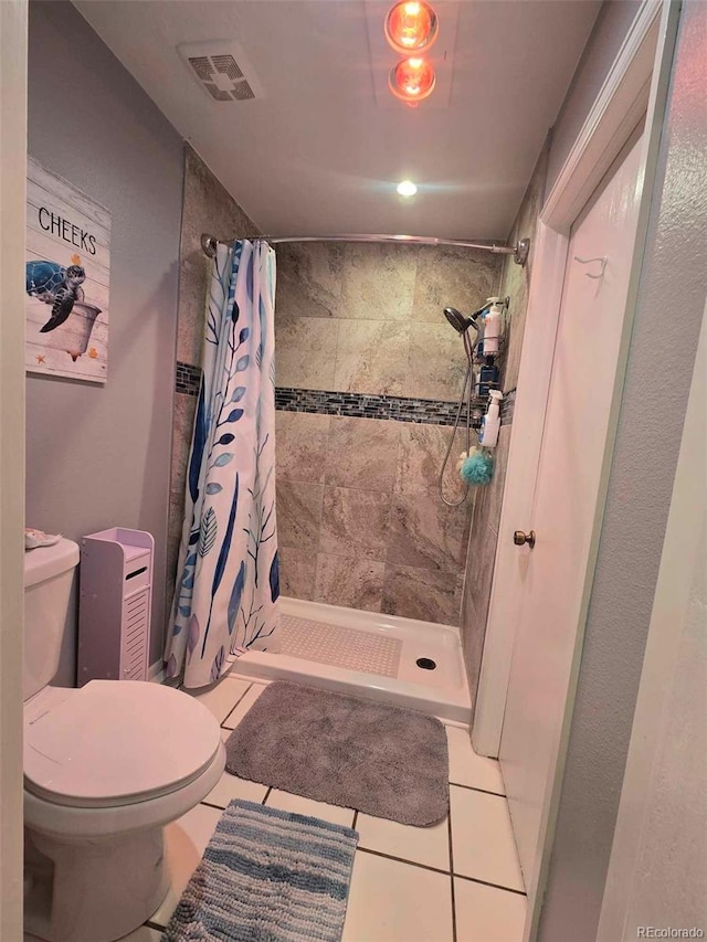 full bath with tile patterned floors, toilet, visible vents, and a stall shower