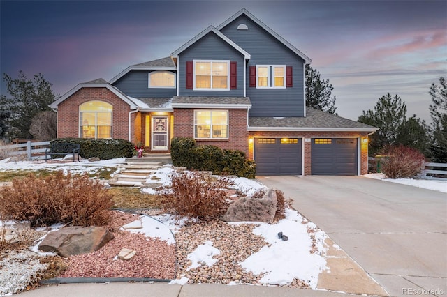 traditional home with an attached garage, brick siding, fence, concrete driveway, and roof with shingles