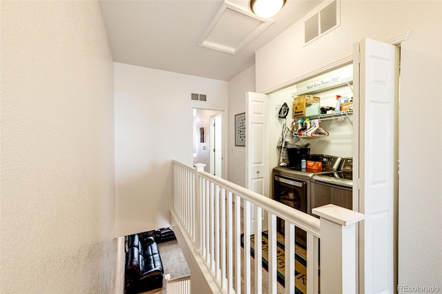 corridor featuring separate washer and dryer