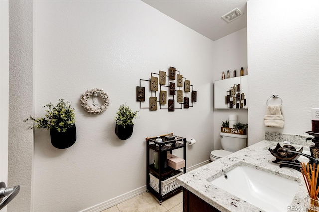 bathroom with tile patterned floors, vanity, and toilet