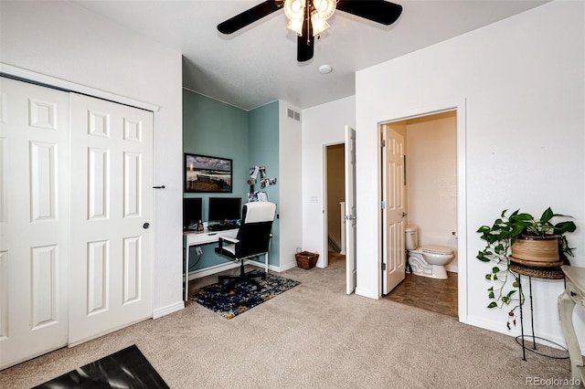 carpeted home office featuring ceiling fan