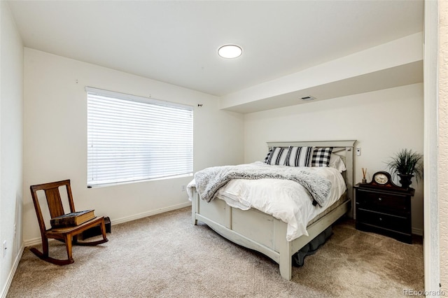 bedroom with carpet floors and baseboards