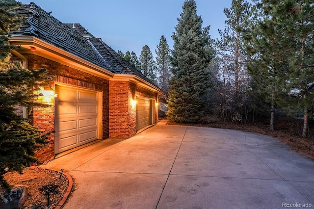 view of home's exterior with a garage and brick siding