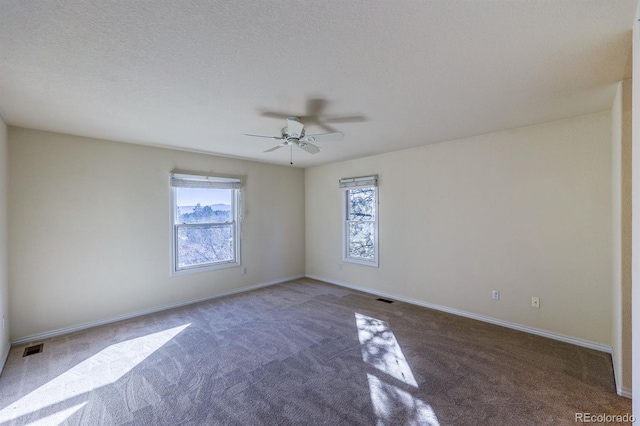 spare room featuring plenty of natural light, baseboards, and ceiling fan