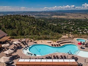 community pool featuring a patio and a community hot tub