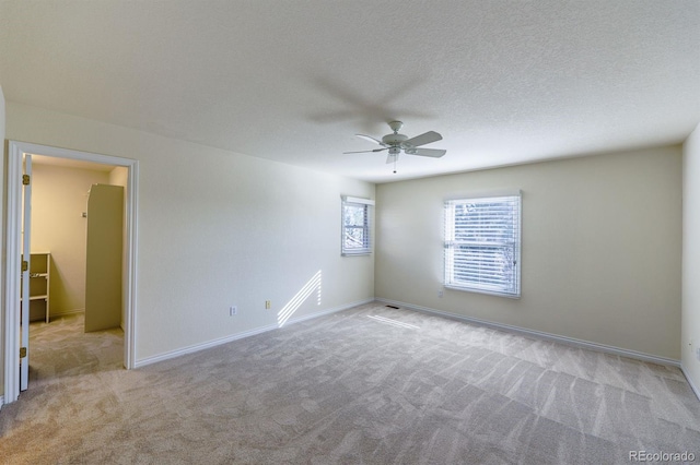 unfurnished room with baseboards, carpet flooring, a textured ceiling, and ceiling fan