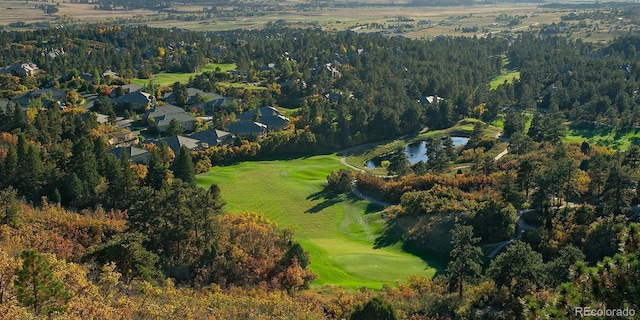 birds eye view of property featuring a forest view and a water view