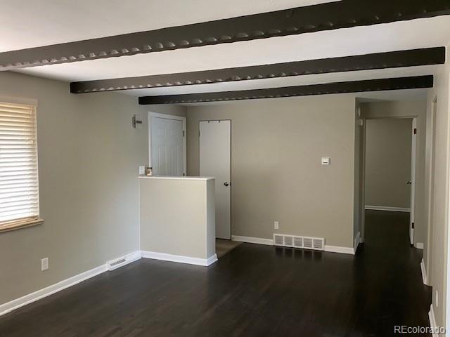 217 Ford St, Golden, CO 80403 - spare room featuring dark wood-type flooring, baseboards, and beamed ceiling
