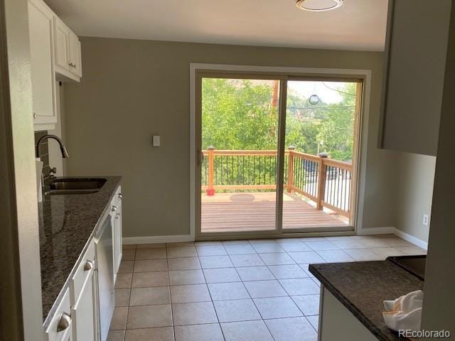 217 Ford St, Golden, CO 80403 - kitchen featuring a sink, baseboards, dark stone counters, and white cabinets