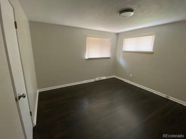 217 Ford St, Golden, CO 80403 - spare room with baseboards and dark wood-style flooring