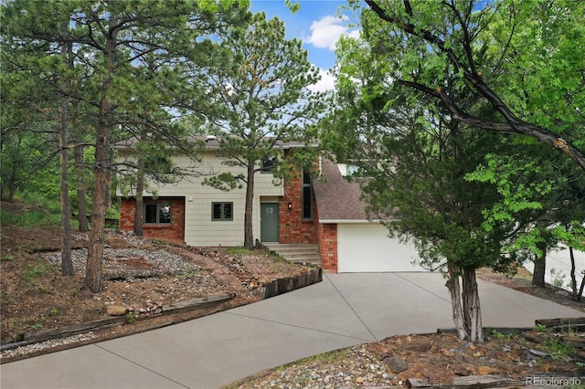 595 Wintery Cir, Colorado Springs, CO 80919 - view of front of house featuring concrete driveway, a garage, and brick siding