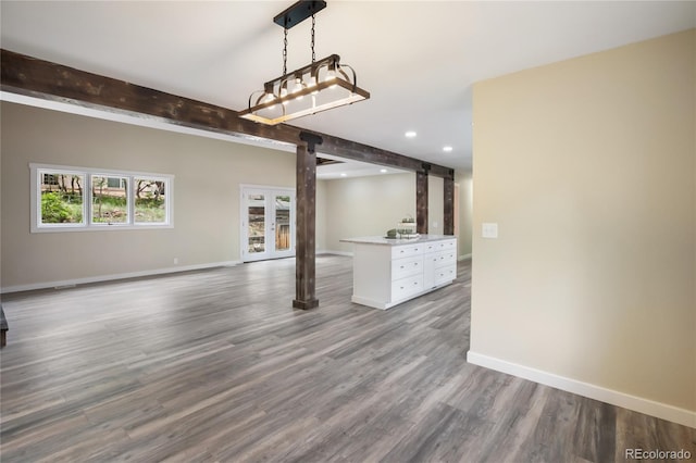 595 Wintery Cir, Colorado Springs, CO 80919 - unfurnished living room featuring baseboards, recessed lighting, wood finished floors, and beam ceiling