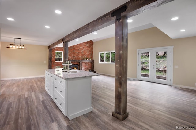 595 Wintery Cir, Colorado Springs, CO 80919 - kitchen featuring white cabinets, baseboards, open floor plan, wood finished floors, and recessed lighting