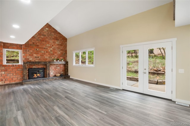 595 Wintery Cir, Colorado Springs, CO 80919 - unfurnished living room featuring wood finished floors, french doors, baseboards, and high vaulted ceiling